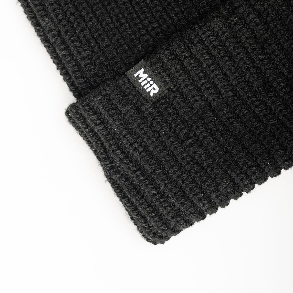 recycled-poly-rib-beanie-v8 WebPDP-RecycledPolyRibBeanie_Studio_TagDetail_Black__BNE002002OS.jpg